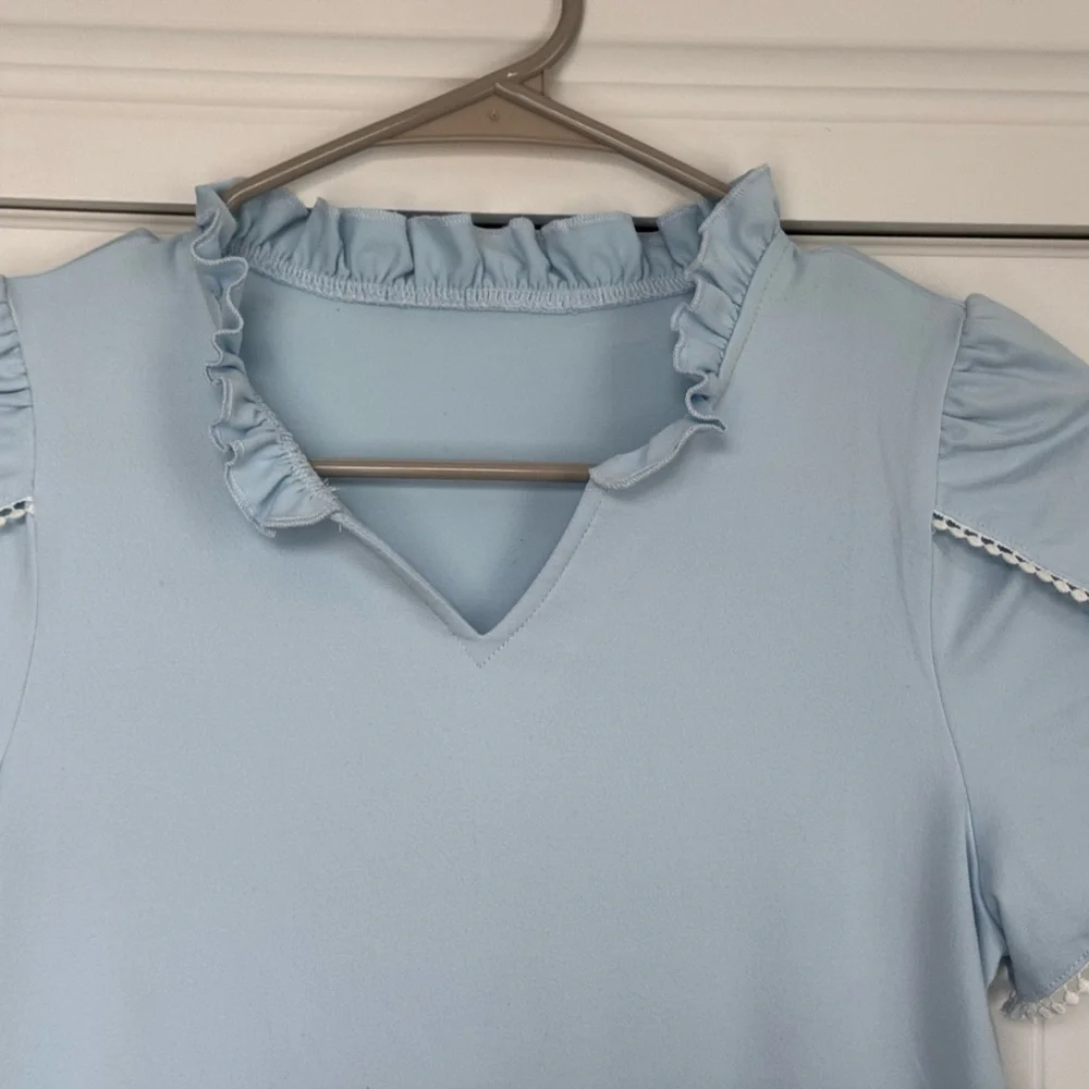 Sky Blue Ruffled Kids Blouse fits like a woman’s small